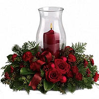 Composition with a candle for the center of the table with leaves, red roses, ri...