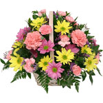 A colourful flower arrangement in a dish/in a basket. ...