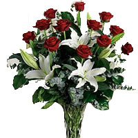 Glorious Casablanka lilies and red roses arranged in a bouquet by a professional...