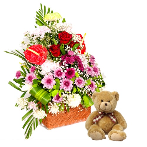 Lovely and Fresh Seasonal Flowers and Teddy Bear in a Rustic Basket