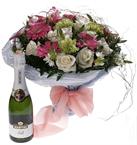 Mixed colorful bouquet and a Bottle of sparkling wine