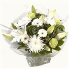 Alluring white lilies nestle among the deepest green leaves and fill the air wit...