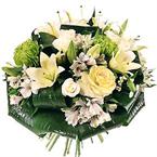 Round bouquet of mostly white flowers with foliage...