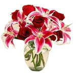 A beautiful vase arrangement of red  roses and  pi...