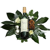 Bottle of white wine at Christmas flower arrangement