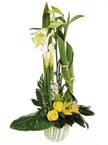 Beautiful high arrangement of white and yellow flo...