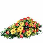 Funeral spray in yellow and orange colours...
