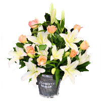 Pristine Bouquet of White Lilies and Pastel Roses in a Bamboo Bucket