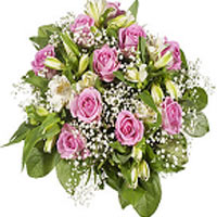 Lovely round tied bouquet of pink roses and season...