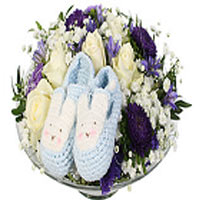 A cute decoration for a baby boy with beautiful blue slippers. The decoration is...