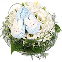 A cute decoration for a baby boy with beautiful blue bunny slippers. The decorat...