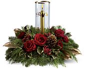 Arrangement includes red roses and red spray roses accented with noble fir, flat...