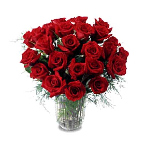 Two dozen long stemmed Roses arranged in a glass vase