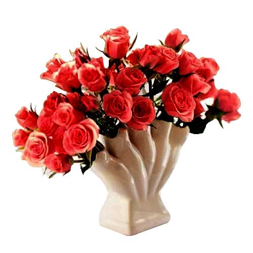 2 dozen peach roses in a vase