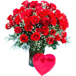 Two dozen red roses in a vase with heart shape cho......  to Cabanatuan_Philippine.asp