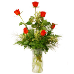 6 red roses in a clear glass vase
