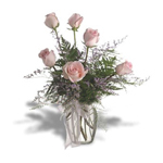 6 pink roses in a clear glass vase.
...