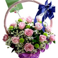 Roses with seasonal flowers in basket