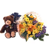 Bouquet of seasonal flowers with teddy bear