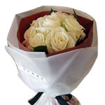 These freshly cut white roses arrive wrapped with ...