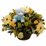 Cute Teddy Bear on a Mix Flowers Basket