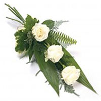 Bouquet of three white roses and green. White color of the flowers is said to co...