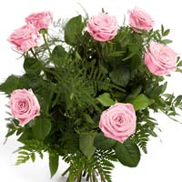 Bouquet of 7 pink roses and green. Pink color of flowers is said to come with th...