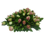 This funeral bouquet of pink and white roses with green....