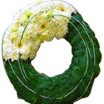 Funeral wreath, traditional cypress rim with flowers packed in a third of the fr...