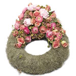 This is a funeral wreath in classic style with Spanish moss and decorated with f...