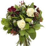 This bouquet of white ane red  roses and berry lea...