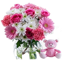 Stylish Display of Multiple Flowers with a Cute Teddy