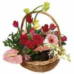 A colourful flower arrangement in a dish/in a bask...