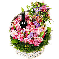 Memorable gift Fragrant pink roses and seasonal flowers in basket are enhanced b...