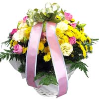 Yellow seasonal flowers in basket